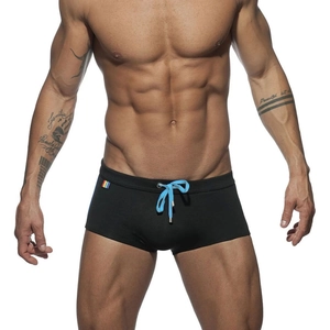 Detail of men's black swimming trunks with light blue drawstring and rainbow side label