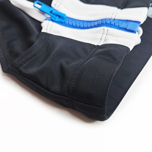 Detail of high-stretch fabric with contrast stripes and durable blue resin zipper
