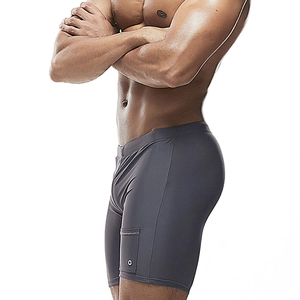 Detail view of dark grey quick-dry swim trunks with side pocket and logo detail