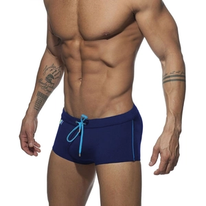 Close-up of navy swim trunks featuring light blue drawstrings and a triple-color accent tag