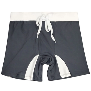 Detail of men's swimming trunks featuring contrast paneling and white adjustable drawstring