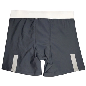Close-up of men's athletic swimming trunks featuring reflective side stripes and elastic waist