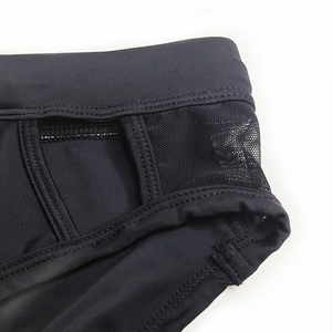 Detail of men's black swim briefs featuring breathable mesh panels and reinforced stitching