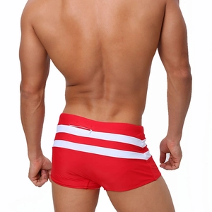 Rear view of red men's swim trunks featuring white stripes and a back zipper pocket