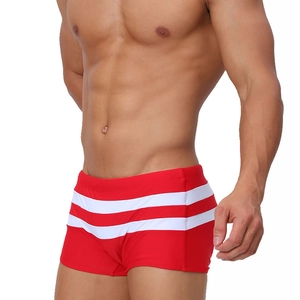 Detail showing red men's trunks with white side stripes and quick-dry fabric texture