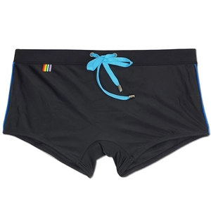 Detail of black swim trunks with blue drawstring and rainbow logo on waistband