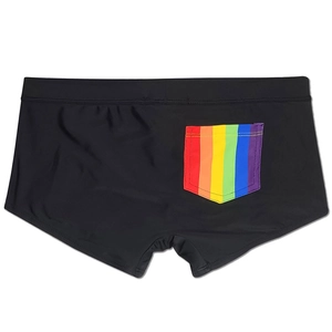 Close-up of black men's swim trunks featuring a rainbow striped back pocket and quick-dry fabric