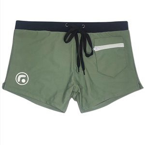 Detail view of olive green men's swim trunks featuring a side zipper pocket and drawstring