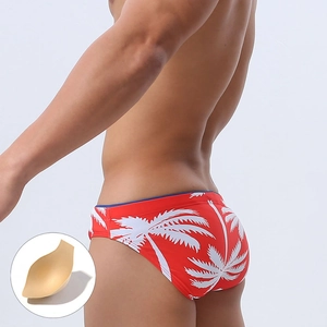 Men's red low-rise swim briefs with white palm tree prints and removable contour pad
