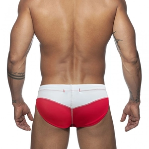 Rear view of low-rise swim briefs featuring red and white color blocking with contrast stitching