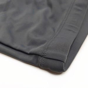 Close-up of quick-dry swim trunks showing high-quality double-needle stitching and grey fabric