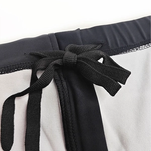 Close-up of men's swim briefs featuring waist drawstring and breathable mesh fabric