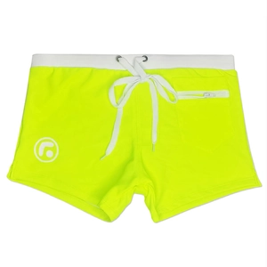 Detail view of neon yellow swimming trunks with white zipper pocket and drawstring waist