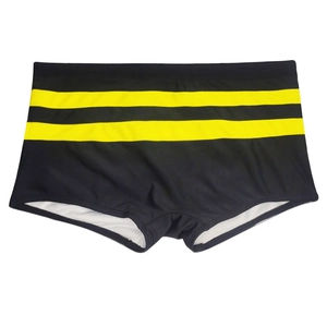 Close-up of black men's swim trunks with yellow stripes and quick-dry lining detail