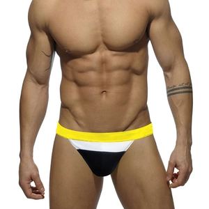 Close-up of low-rise bikini swim trunks with yellow white and black color block pattern