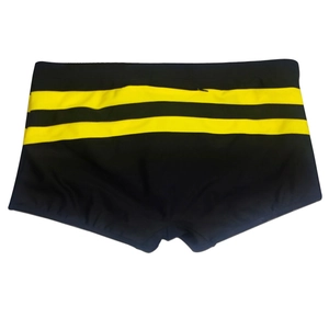 Detail of men's swimming trunks with black elastic fabric and yellow stripe decoration