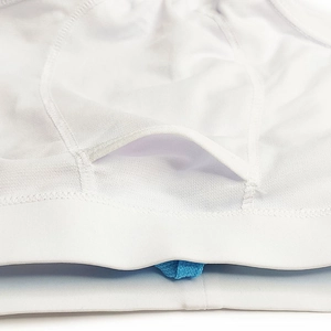 Macro view of white mesh swim trunks with reinforced stitching and hidden key pocket detail