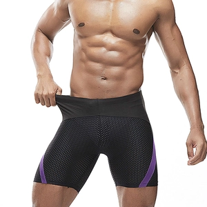 Detail of men's athletic swimwear showing purple side panels and breathable hexagonal mesh