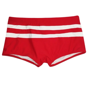 Detail of red men's swim trunks featuring white double stripes and elastic fabric