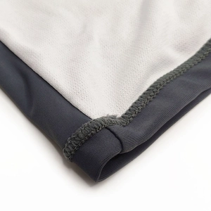 Detailed close-up of quick-dry fabric stitching and breathable mesh lining of swim shorts