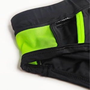 Detail of black fabric and neon green mesh with reinforced double-stitched seams
