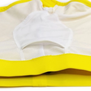 Detail of yellow swim trunks showing white mesh lining and supportive inner pocket