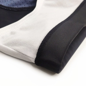 Macro shot of breathable mesh fabric and elastic seams on men's patchwork swim trunks