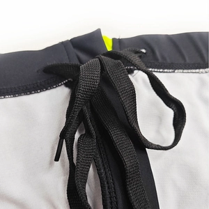 Close-up of men's swimming briefs waist with black elastic band and neon yellow lining
