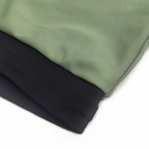 Close-up of olive and black ribbed knit elastic fabric used for men's swim trunks
