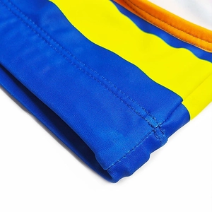 Close-up of color-blocked swimwear fabric with durable stitching and elastic texture
