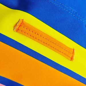 Macro shot of colorful striped fabric with durable double-stitched orange strap detail