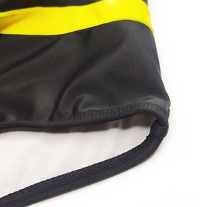 Close-up of yellow and black quick-dry swim trunks with professional reinforced stitching