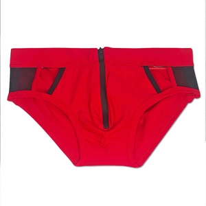 Detail of red men swim briefs featuring black mesh side panels and a front zipper