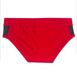 Detail view of red men's swim trunks featuring black breathable mesh side stitching