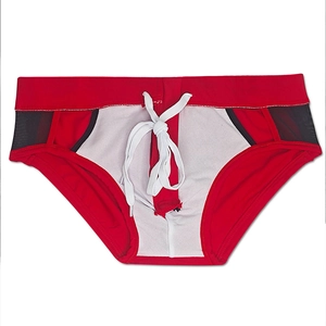 Detailed view of red men's swim briefs featuring black mesh side panels and white drawstrings