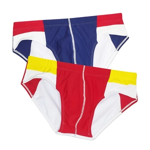 Flat lay of men's athletic swim briefs in navy and red with contrast stitching detail
