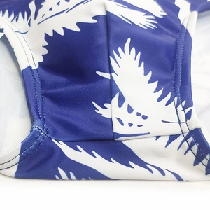 Detail shot of blue palm leaf print fabric with premium stitching and elastic texture