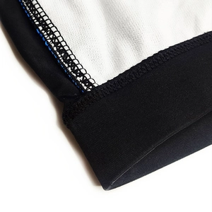 Detailed close-up of professional stitching and mesh fabric on men's rainbow swim trunks
