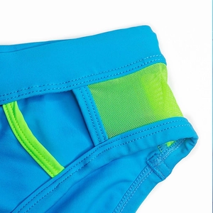 Close-up of men's blue swimwear showing neon green mesh detail and high-quality stitching