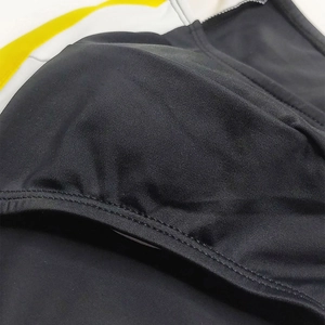 Detailed close-up of men's black swim briefs showing elastic fabric and durable stitching