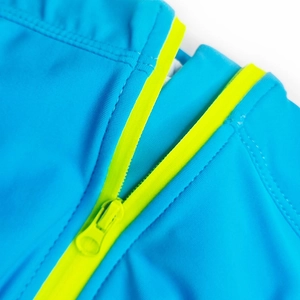 Detail of blue men's swimwear featuring a yellow zipper and high-stretch fabric