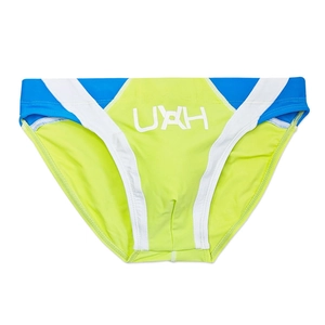 Close-up of men's athletic swim briefs with bright neon green and blue color blocking