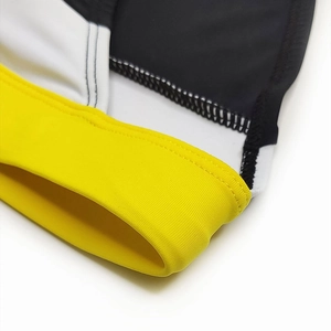 Detail view of the yellow, white, and black color-block stitching on the men's swim briefs