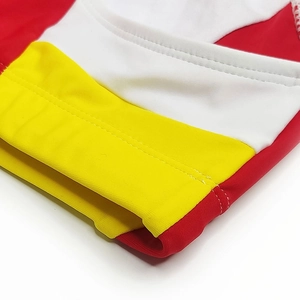 Detailed close-up of high-elasticity fabric stitching on men's color-block swimwear