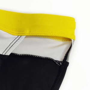Detailed view of color block men's swimwear featuring elastic waist and double stitching