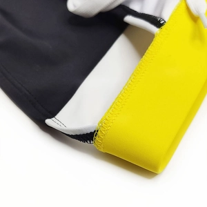 Detail of men's swim briefs showing contrast stitching, yellow seams, and white drawstring