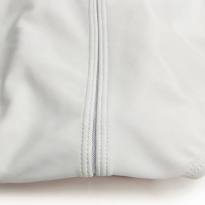 Close-up of white mens swim trunks featuring breathable mesh seams and durable stitching