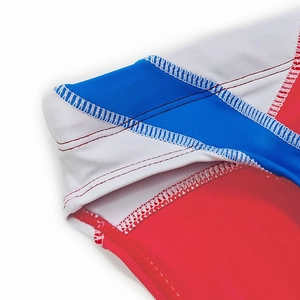 Close-up of flatlock stitching on tricolor patchwork men's compression swimwear fabric