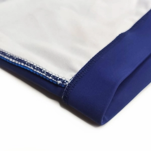 Detail of high-elasticity fabric and flatlock stitching on navy blue mens swim shorts