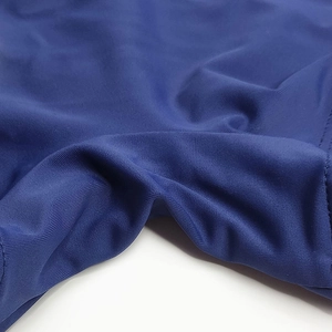 Detailed view of dark blue swimwear fabric with flat reinforced stitching and texture